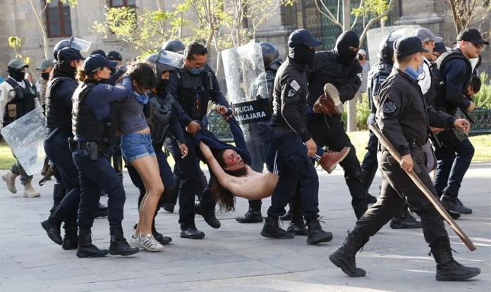 Police in Guadalajara arrest protesters in June.
