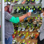 A customer's temperature is checked at a store in Guadalajara in July.