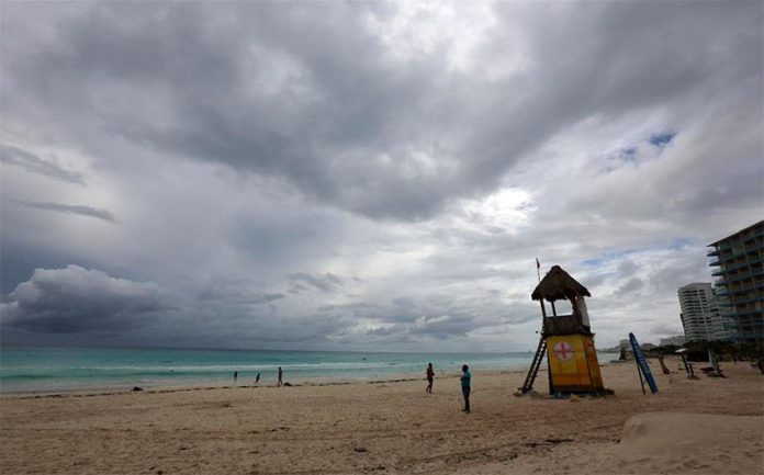 Ominous skies and a near-empty beach in Cancún prior to the arrival of Hurricane Delta.