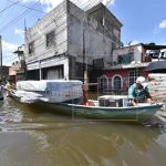 Flood victims salvage their belongings from flooded homes in Tabasco.