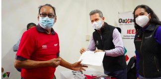 Pacheco, left, receives his diploma.