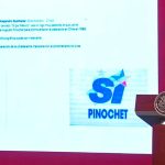 The president displays the two logos during his press conference.