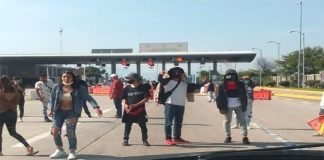 A motorist approaches toll plaza extortionists in Morelos.