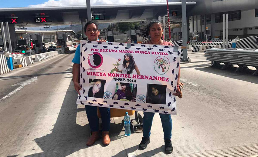 Families of missing persons occupy a toll plaza earlier this year.