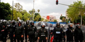 Police prevent access to a Columbus statue in Buenavista, Mexico City.