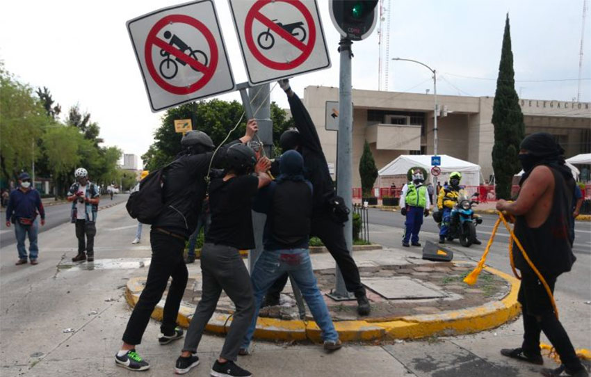 Foiled in their attempts to take down Columbus statue in Mexico City, protesters tear down street signs instead.