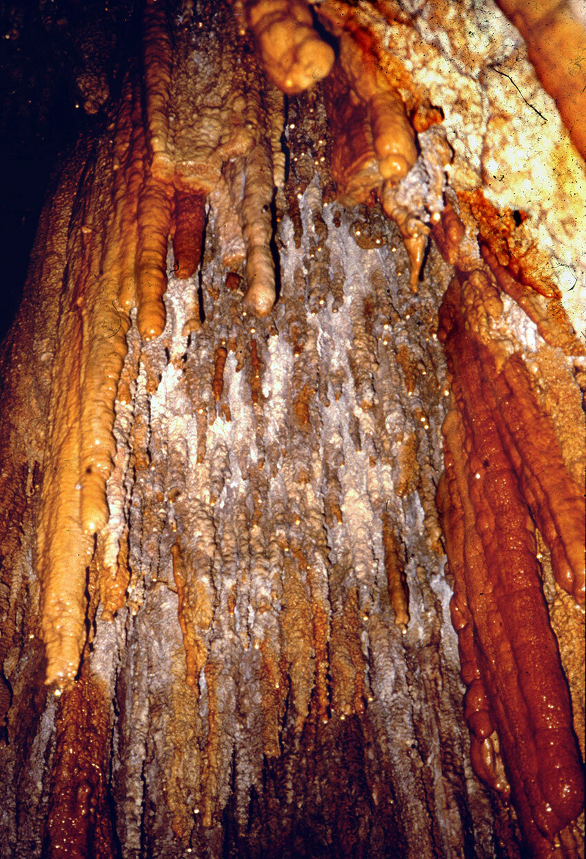 Colorful stalactites are found both inside and outside El Salto Cave.