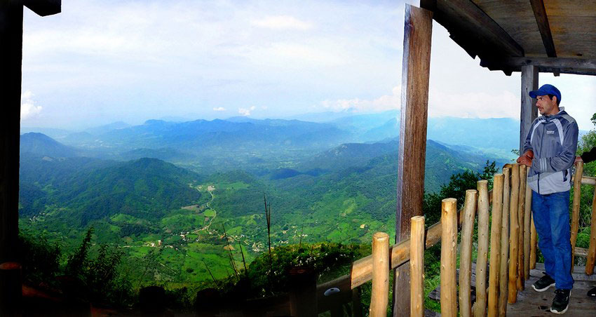 A local guide gazes out at the countryside from Mirador El Filete