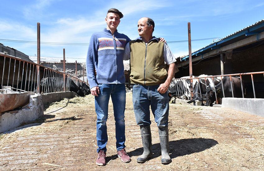 Flavio Stefanoni Merlo (left) plans to succeed his father Luís (right), a fourth-generation dairyman. He'll be a dying breed in Chipilo.