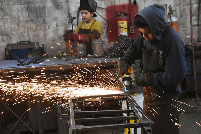 Workers prepare metal frames for furniture at a Chipilo factory.