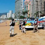 Officials patrol a beach in Acapulco.