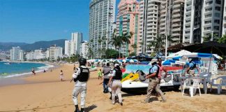Officials patrol a beach in Acapulco.
