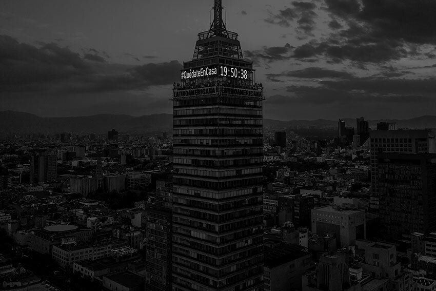 Mexico City's skyscape at dusk with the Covid slogan, "Quedate en Casa" 