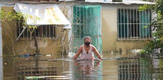 A woman ventures into a flooded street in Tabasco.