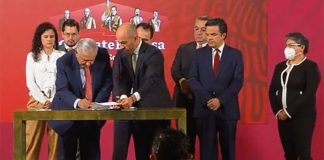 The president signs the proposal Thursday at the morning press conference.