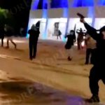 An officer fires his gun during Monday's protest.