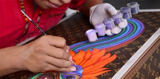 A Zapotec artist at work on a Vuitton trunk.