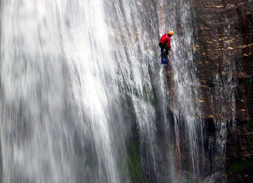 Medina rappelling down a waterfall in Syange Khola Canyon, Nepal.