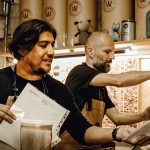 Brew masters Francisco “Paco” Aureliano, left, and Michael Boudey try out a new recipe.