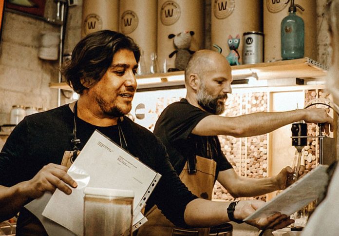 Brew masters Francisco “Paco” Aureliano, left, and Michael Boudey try out a new recipe.
