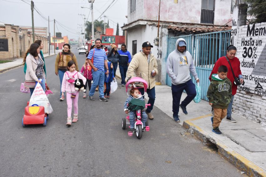 Participants go door-to-door to wish neighbors a good upcoming year.