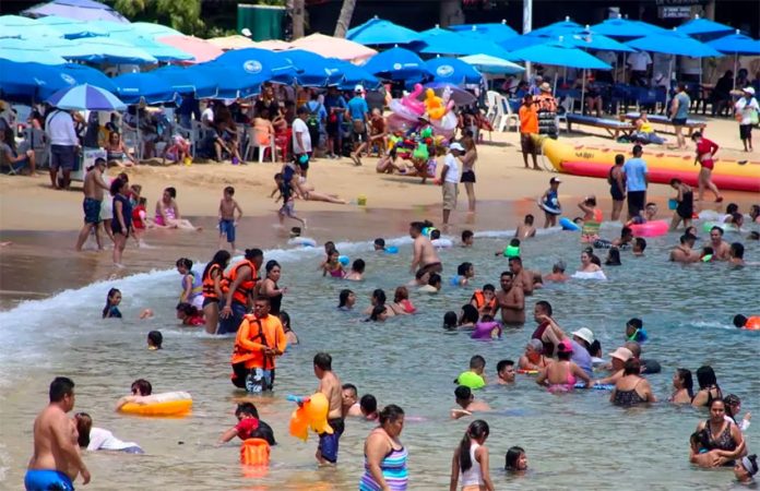 A busy beach in Acapulco last March.