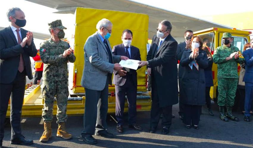 Senior officials welcome the arrival of the Covid vaccine at the Mexico City airport.