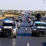 Police escort the caravan of Mexicans returning home for the holidays.