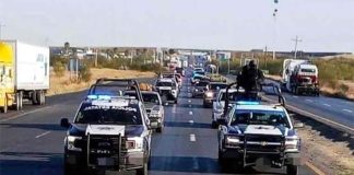 Police escort the caravan of Mexicans returning home for the holidays.