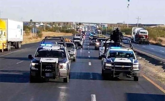 Police escort the caravan of Mexicans returning home for the holidays.