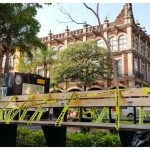 Yellow caution tape adorns a park bench in the center of Cuernavaca.