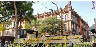 Yellow caution tape adorns a park bench in the center of Cuernavaca.