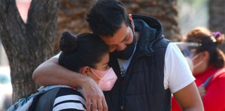 A couple share a moment of grief in Mexico City.