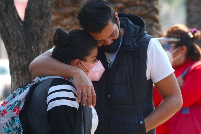 A couple share a moment of grief in Mexico City.