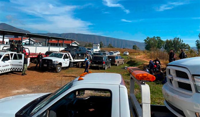 Vehicles abandoned by crime gangs in Michoacán are towed by authorities Thursday.