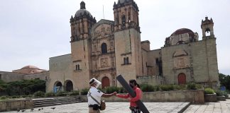 A state official provides hand sanitizer outside the Church of Santo Domingo in Oaxaca city.