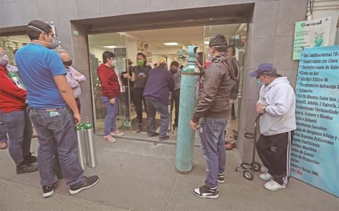 Customers line up for oxygen refills at a Mexico City supplier.