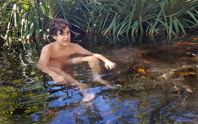Relaxing in the transparent, 38-degrees Celsius waters around Las Cuevas.