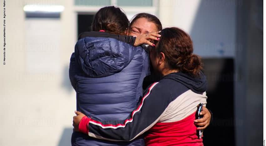 Family members grieve the death of a victim of the coronavirus.