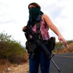 A woman guards the highway into El Terrero.