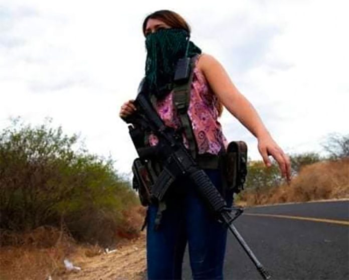A woman guards the highway into El Terrero.