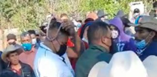 During Wednesday's melee, the mayor appears to be removing the noose from his neck.