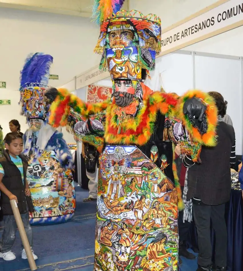 Chinelos dancers with highly-ornate garb performing for the opening of the Expo de los Pueblos Indígenas in Mexico City in 2018.