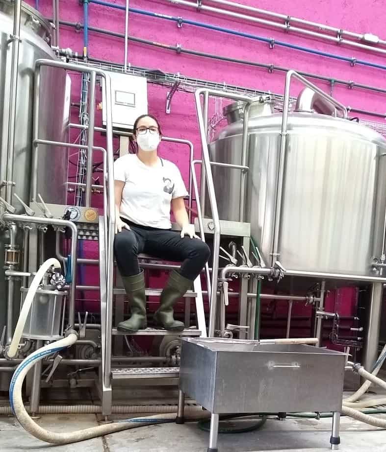 Domínguez surrounded by her brewing equipment.