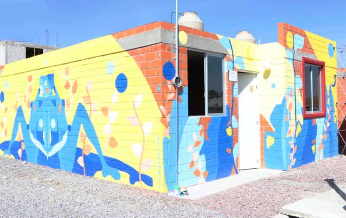 Murals adorn the first two houses in a new sustainable housing program.