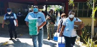 Doses of vaccine arrive at a vaccination center for teachers in Campeche.
