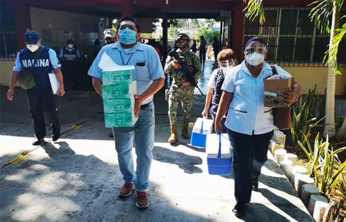 Doses of vaccine arrive at a vaccination center for teachers in Campeche.