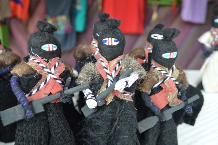 Zapatista dolls with trademark balaclava, rifle and bandolier.