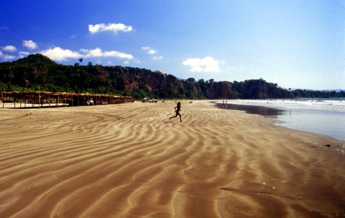 Long, beautiful Los Cocos beach has soft sand and small waves.