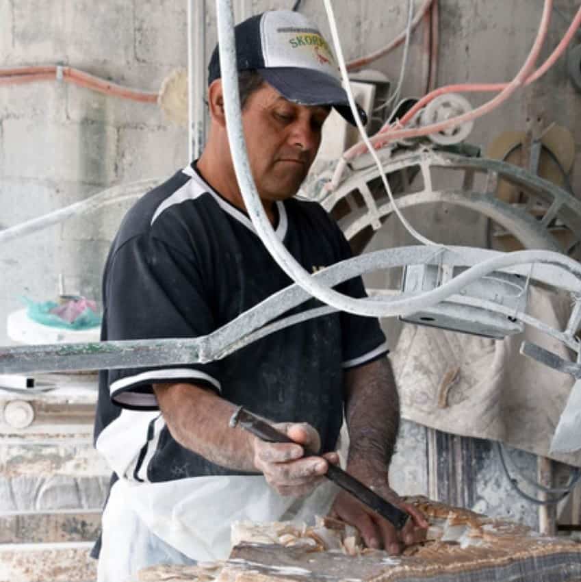 Francisco Camargo works on a marble slab.